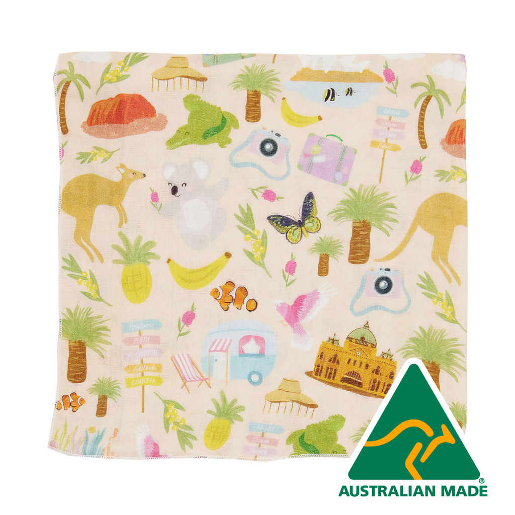 Fabric with colorful patterns of animals, objects, and landmarks on a beige background, featuring an Australian Made logo.