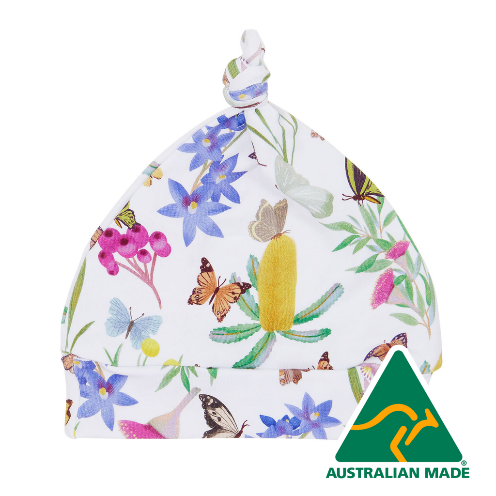Baby hat with floral and butterfly pattern on a white background, Australian Made logo visible