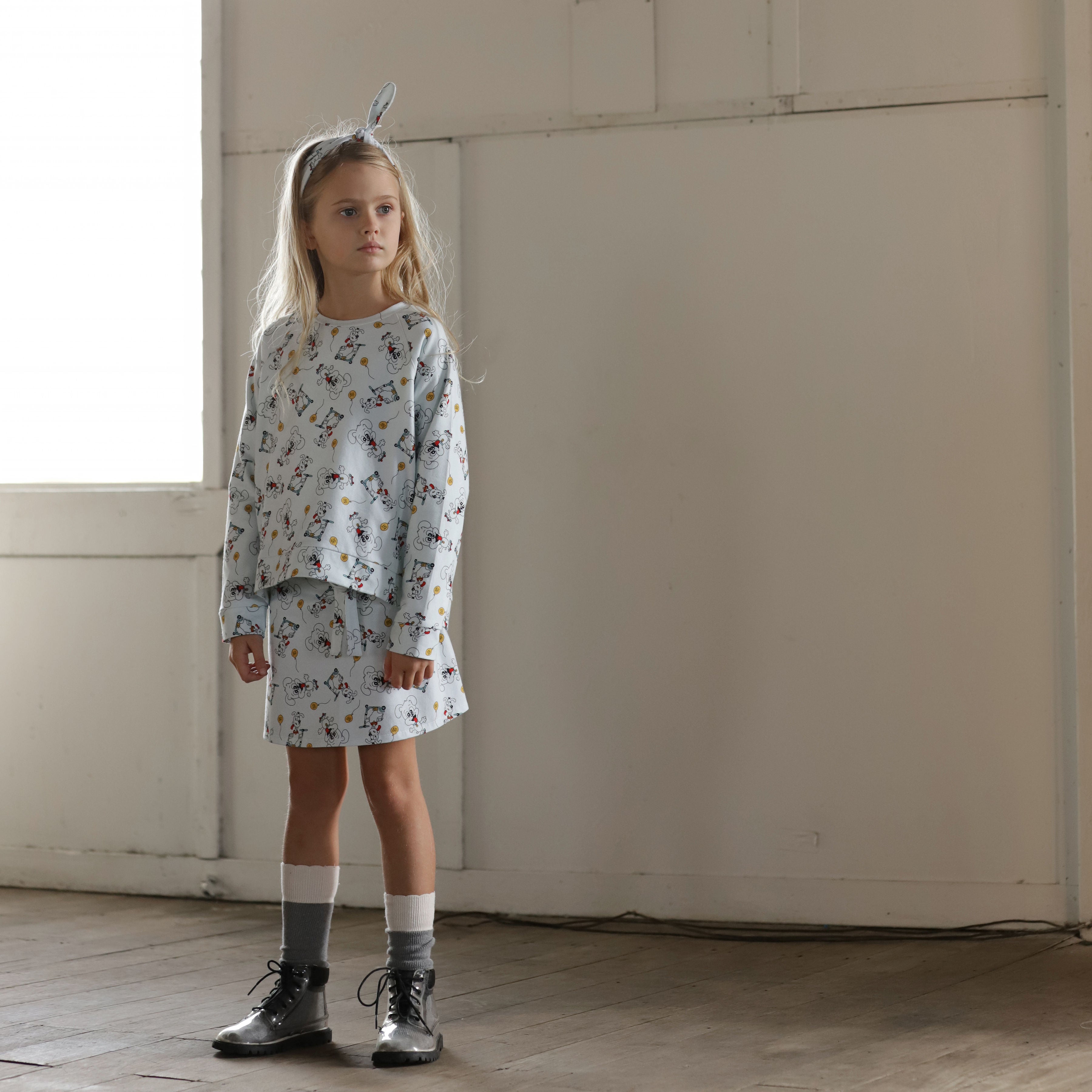 Girl wearing puppy print wrap skirt and matching organic cotton sweater