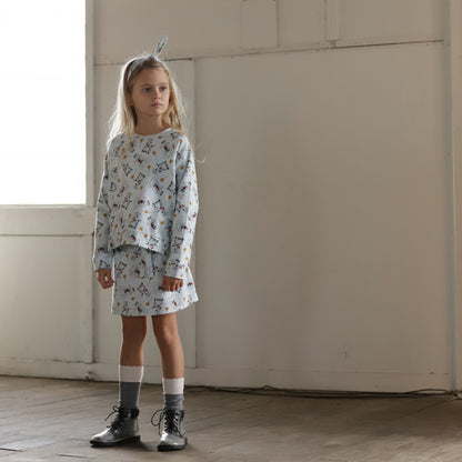 Girl wearing puppy print wrap skirt and matching organic cotton sweater