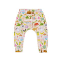 Aussie Road Trip organic cotton kids pants featuring playful Australian illustrations including kangaroos, koalas, caravans, cameras and tropical holiday icons on a soft beige background.