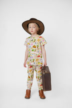 Child wearing an Australian made organic cotton Aussie Road Trip kids tee with cowboy hat and vintage suitcase