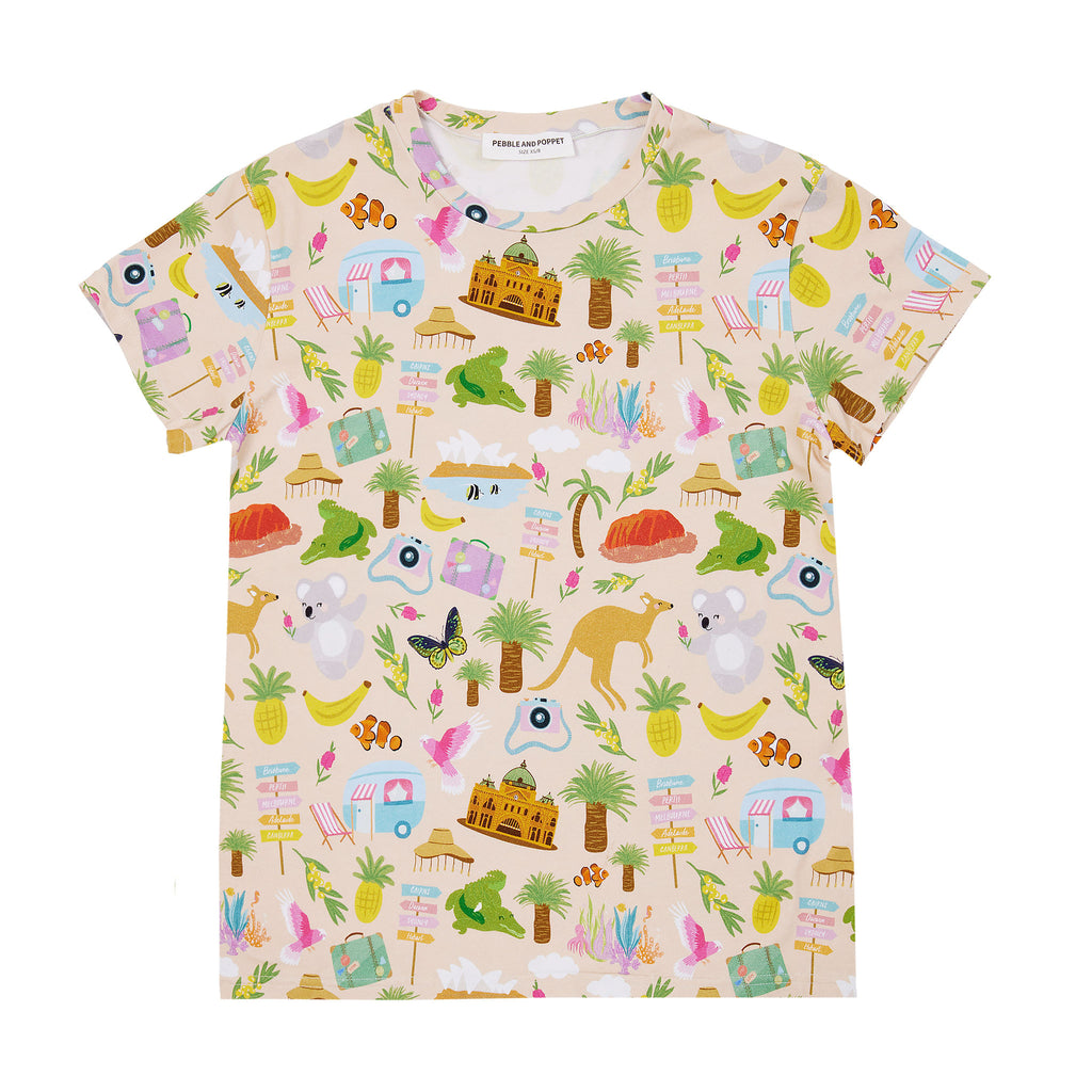 Aussie Road Trip women’s t-shirt featuring whimsical Australian travel illustrations including kangaroos, koalas, caravans and tropical holiday icons on a soft beige background.