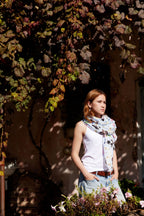 Fashion lifestyle image of a woman styling a lightweight Australian bird print scarf with casual denim.