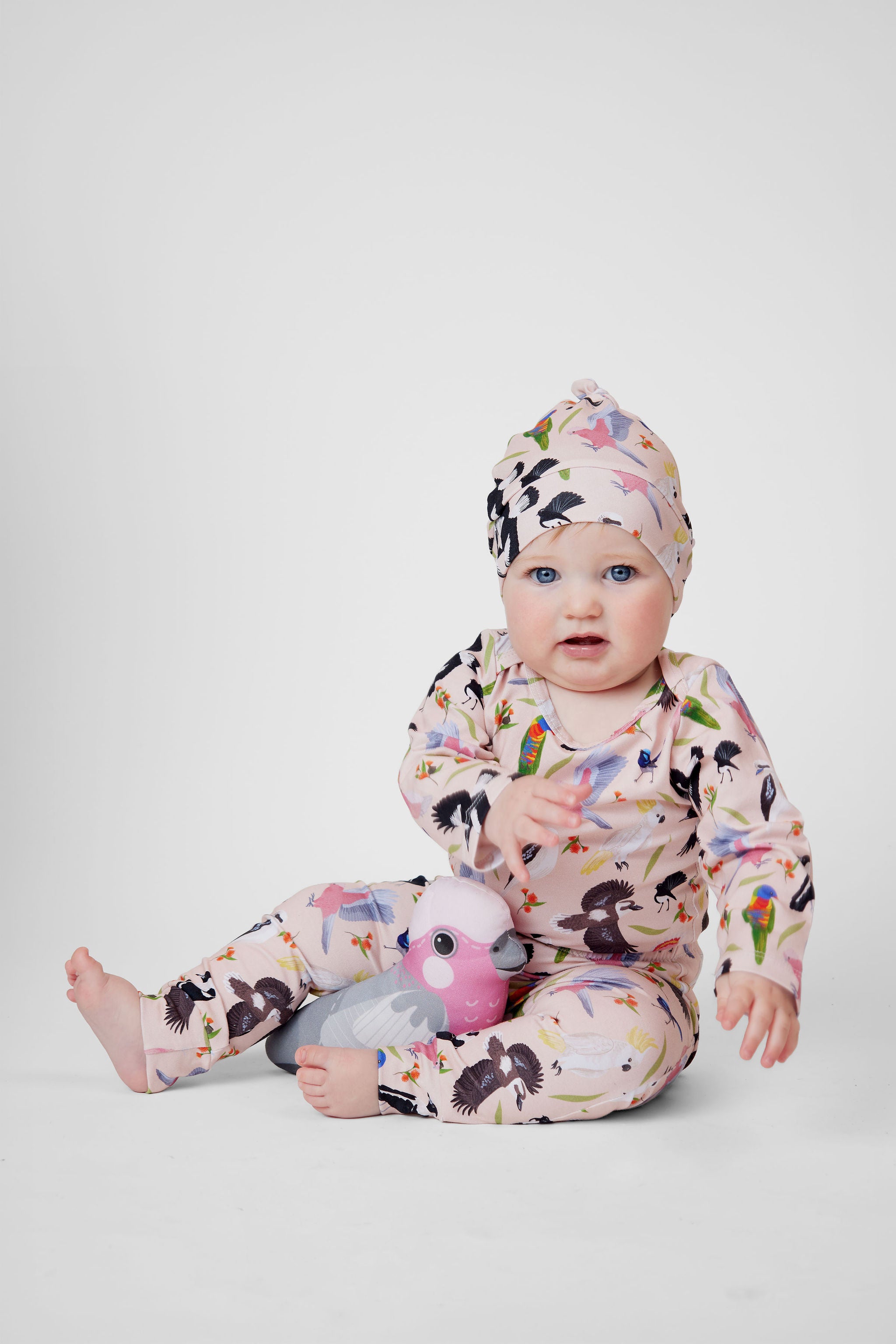Baby wearing pink Backyard Birds Australian bird print beanie by Pebble and Poppet.
