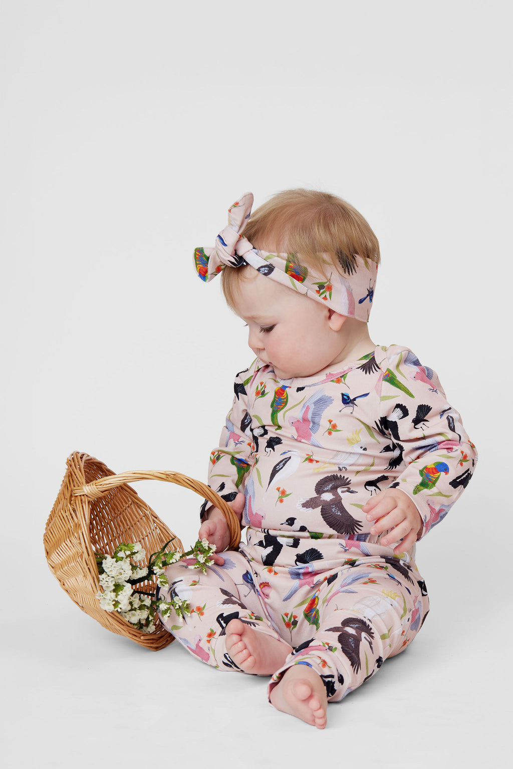 Baby wearing pink Backyard Birds Australian bird print headband and matching lounge set