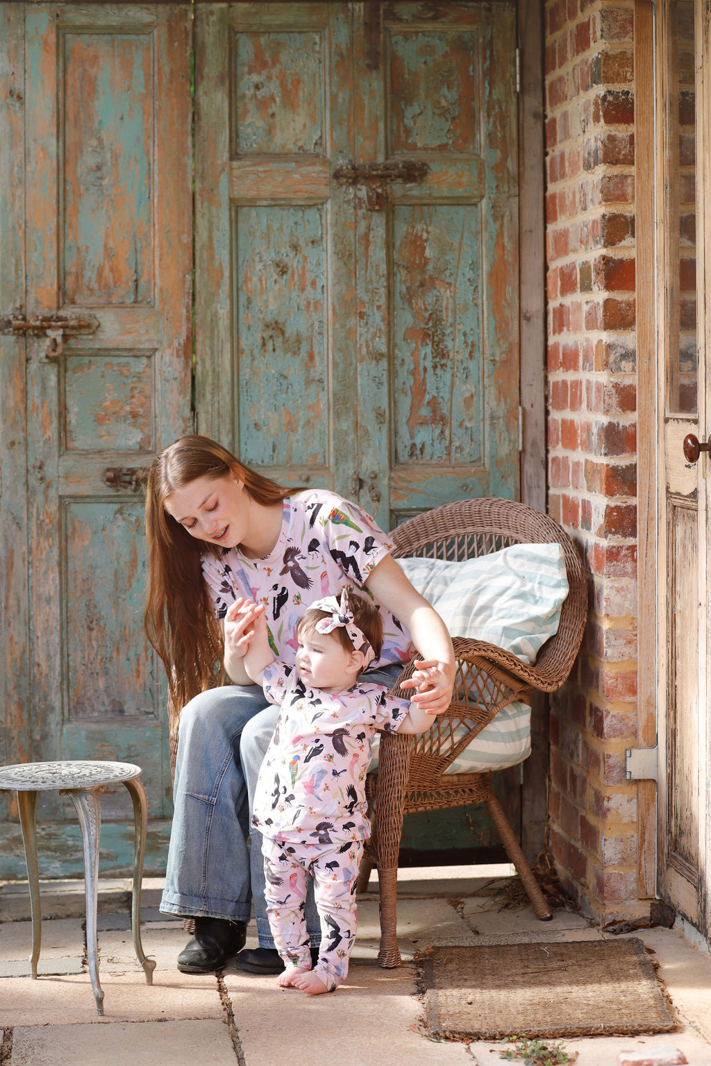 Toddler wearing Backyard Birds baby pants and matching top with mother outdoors in rustic Australian setting