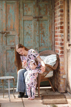 Toddler wearing Backyard Birds baby pants and matching top with mother outdoors in rustic Australian setting