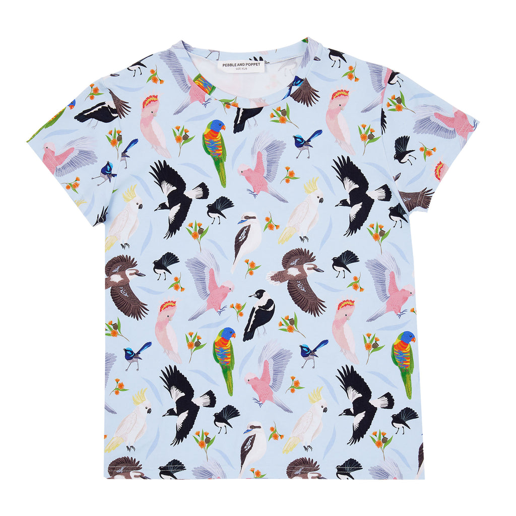 Backyard Birds women’s t-shirt featuring colourful Australian native bird illustrations including galahs, cockatoos, magpies and rainbow lorikeets on a soft blue background