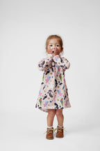 Toddler girl wearing pink Australian bird print long sleeve dress by Pebble and Poppet