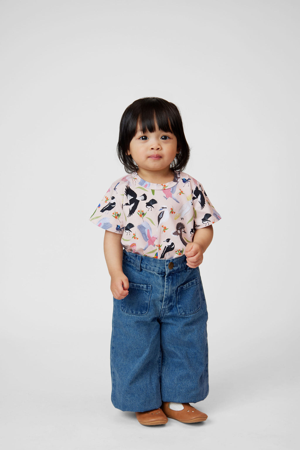 Toddler wearing Backyard Birds Australian bird print tee styled with relaxed denim pants.