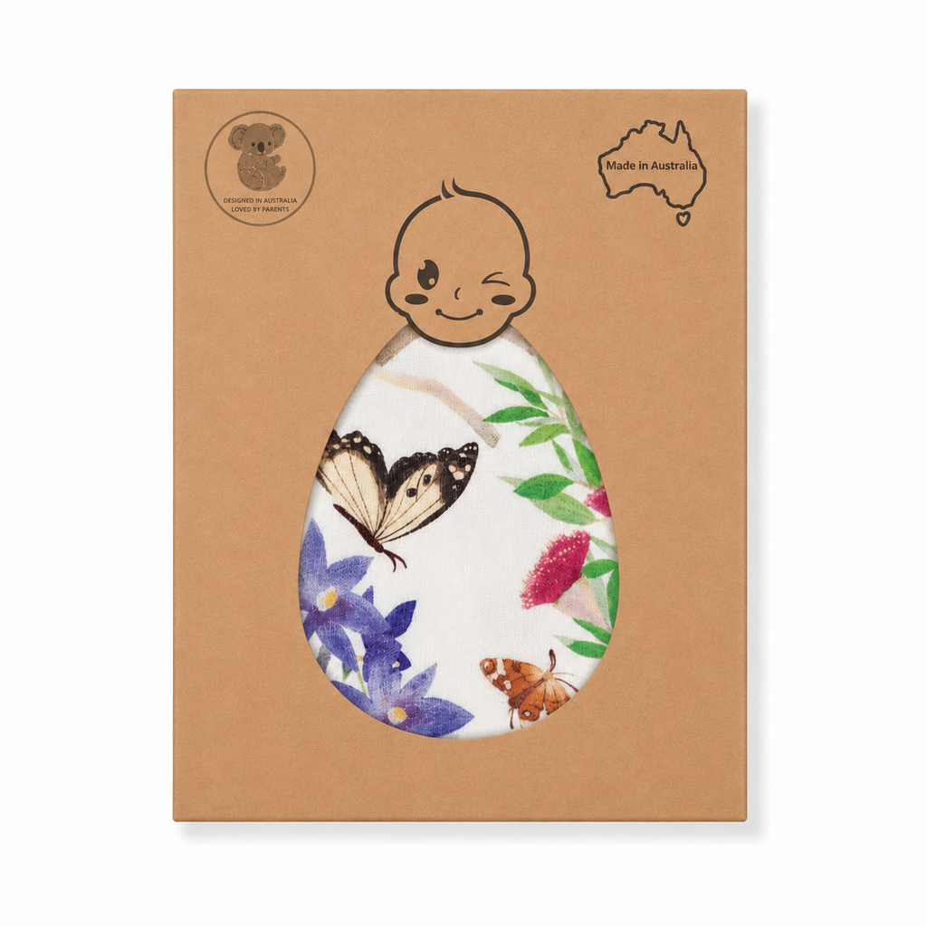 Butterfly Flora bamboo swaddle in gift box by Pebble and Poppet, featuring Australian wildflowers and butterflies. Australian-made baby swaddle presented in eco-friendly packaging.