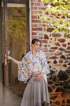 Young woman wearing the Butterfly Flora White bamboo scarf by Christie Williams featuring butterflies and Australian florals
