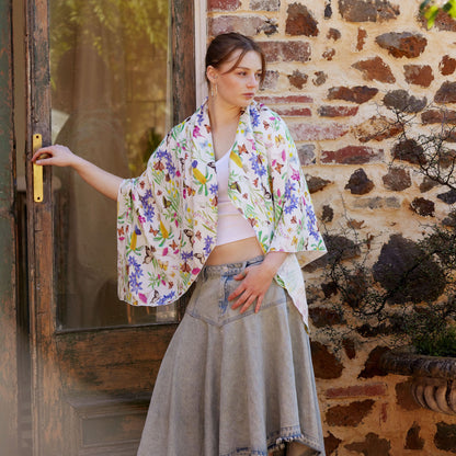 Young woman wearing the Butterfly Flora White bamboo scarf by Christie Williams featuring butterflies and Australian florals