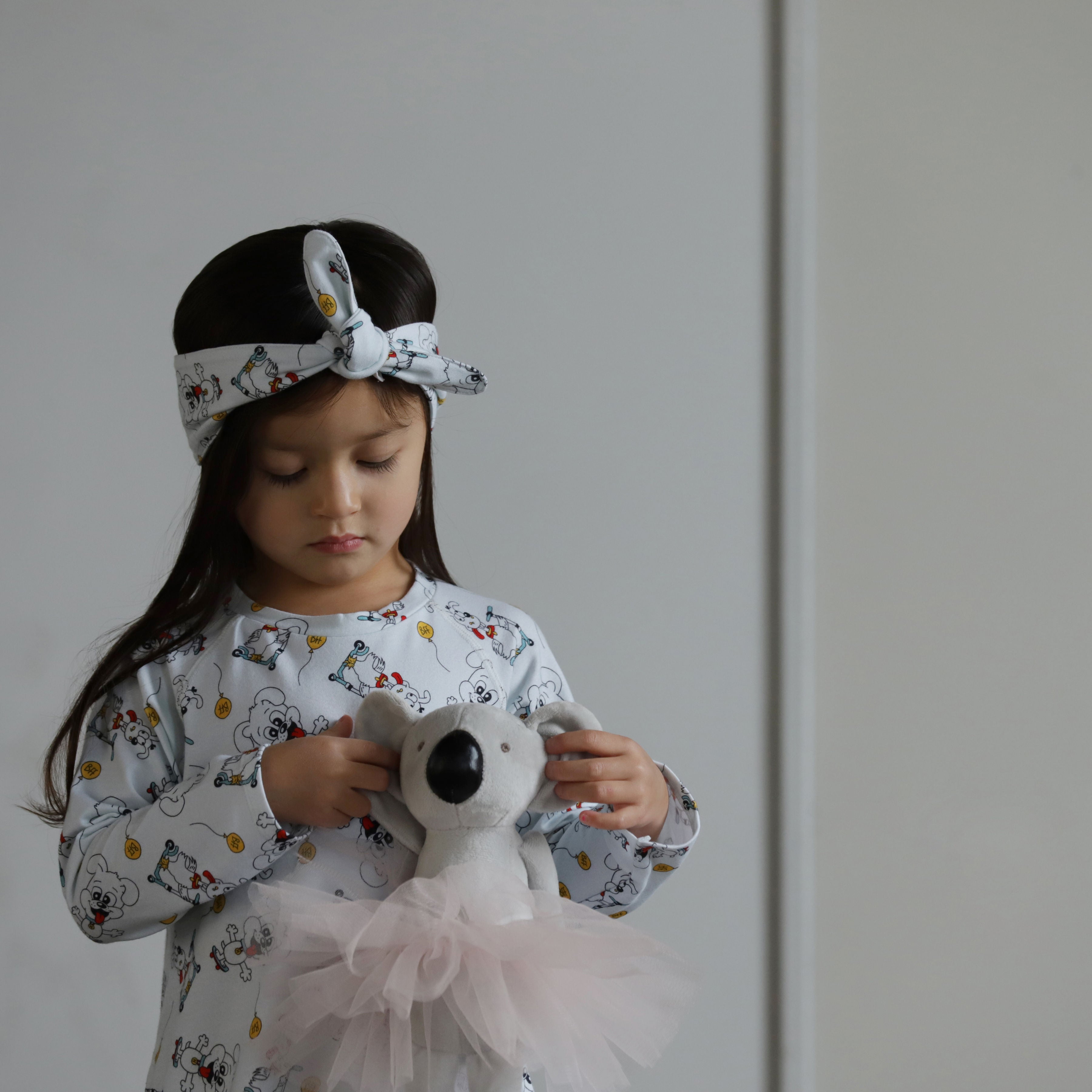 Little girl wearing puppy print organic cotton headband