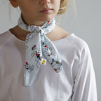 Little girl wearing puppy print organic cotton scarf