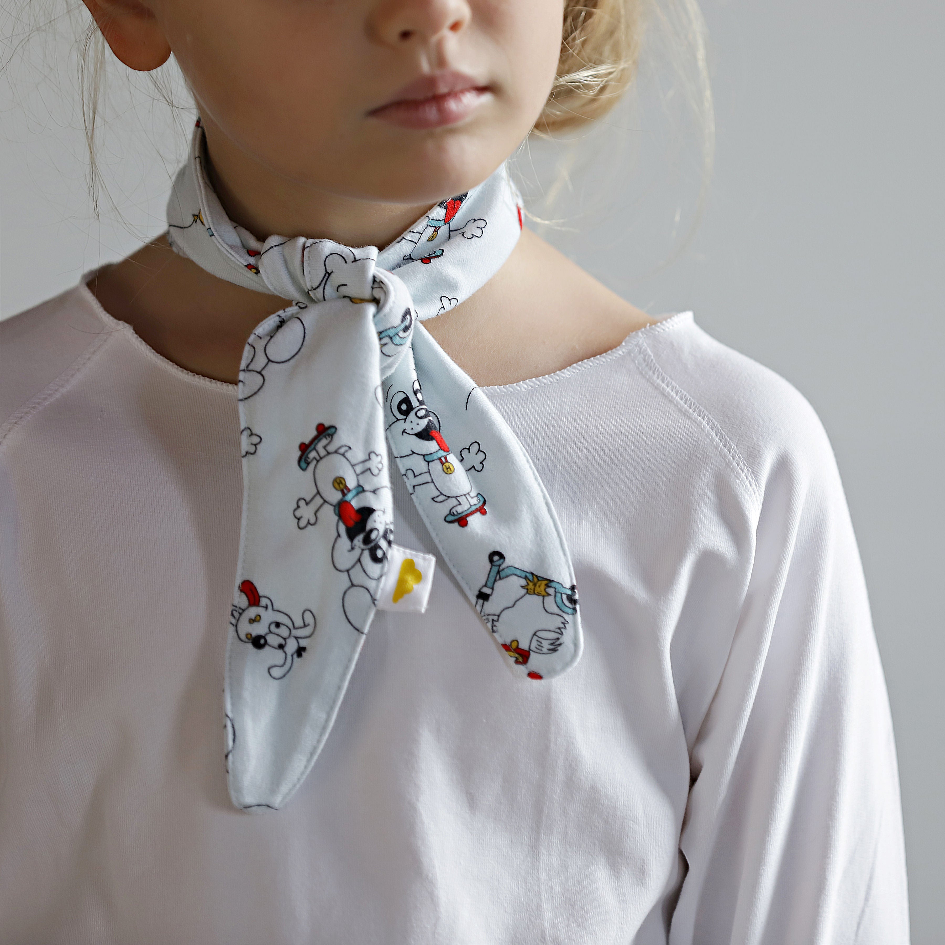 Little girl wearing puppy print organic cotton scarf