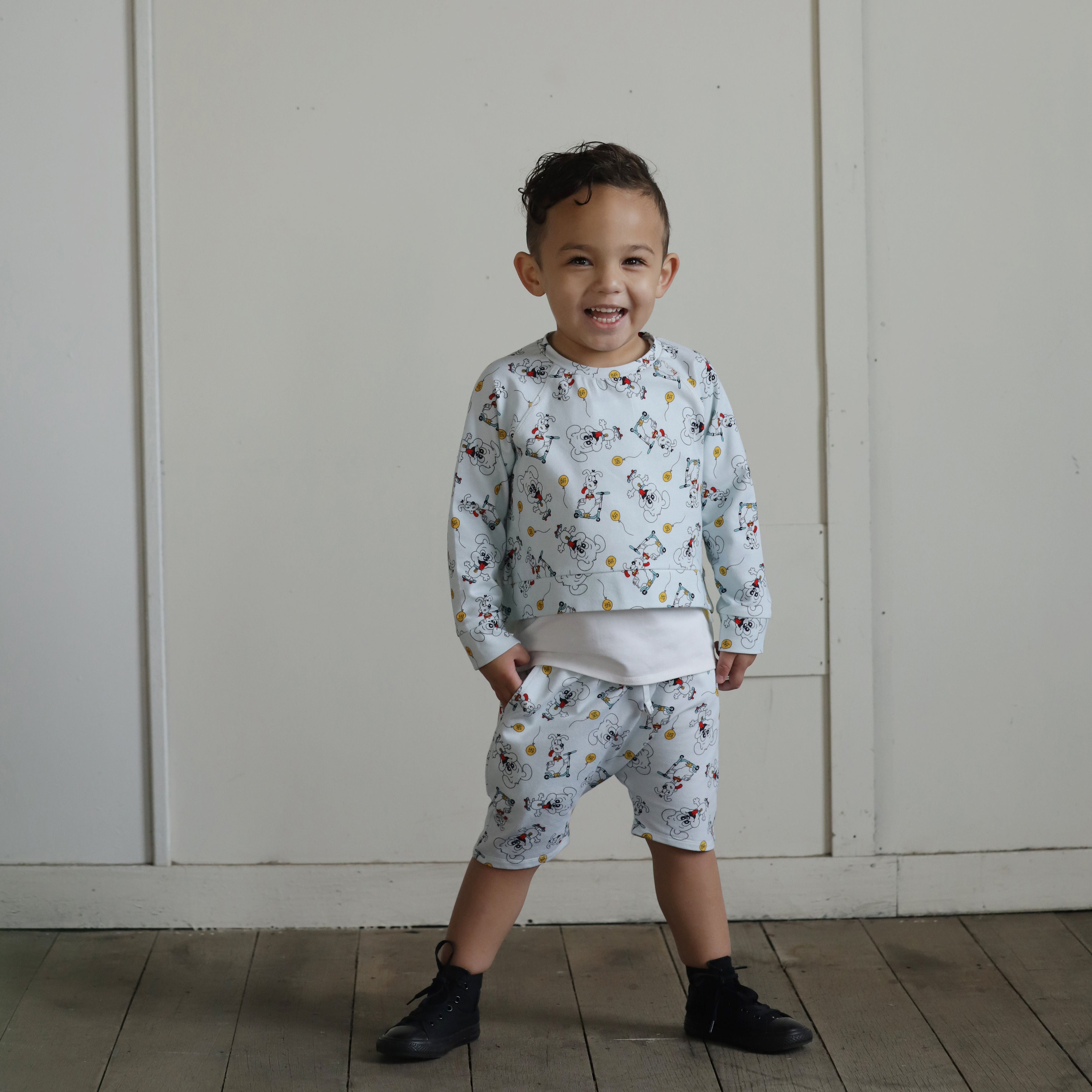 Boy wearing puppy print organic cotton sweatshirt and shorts set
