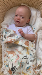 Feathers and Fur swaddled Baby boy playing