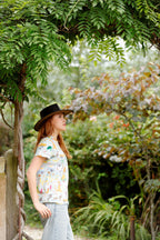 Woman wearing the Summer Down Under Australian print adult t-shirt under a garden archway