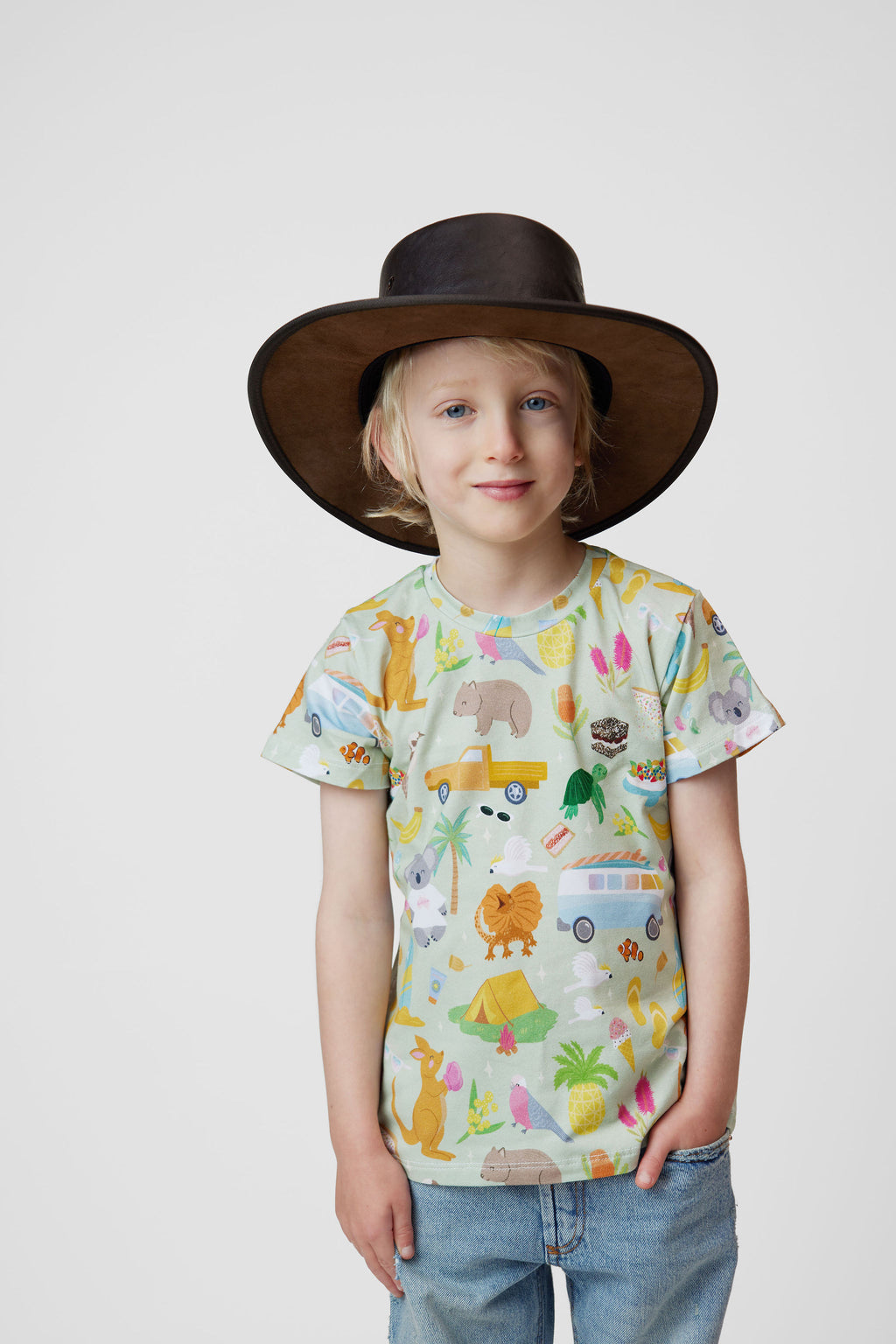 Child wearing Pebble and Poppet Summer Down Under organic cotton kids t-shirt with Australian inspired print featuring kangaroos, kombis, camping and native animals. Designed and made in Australia.