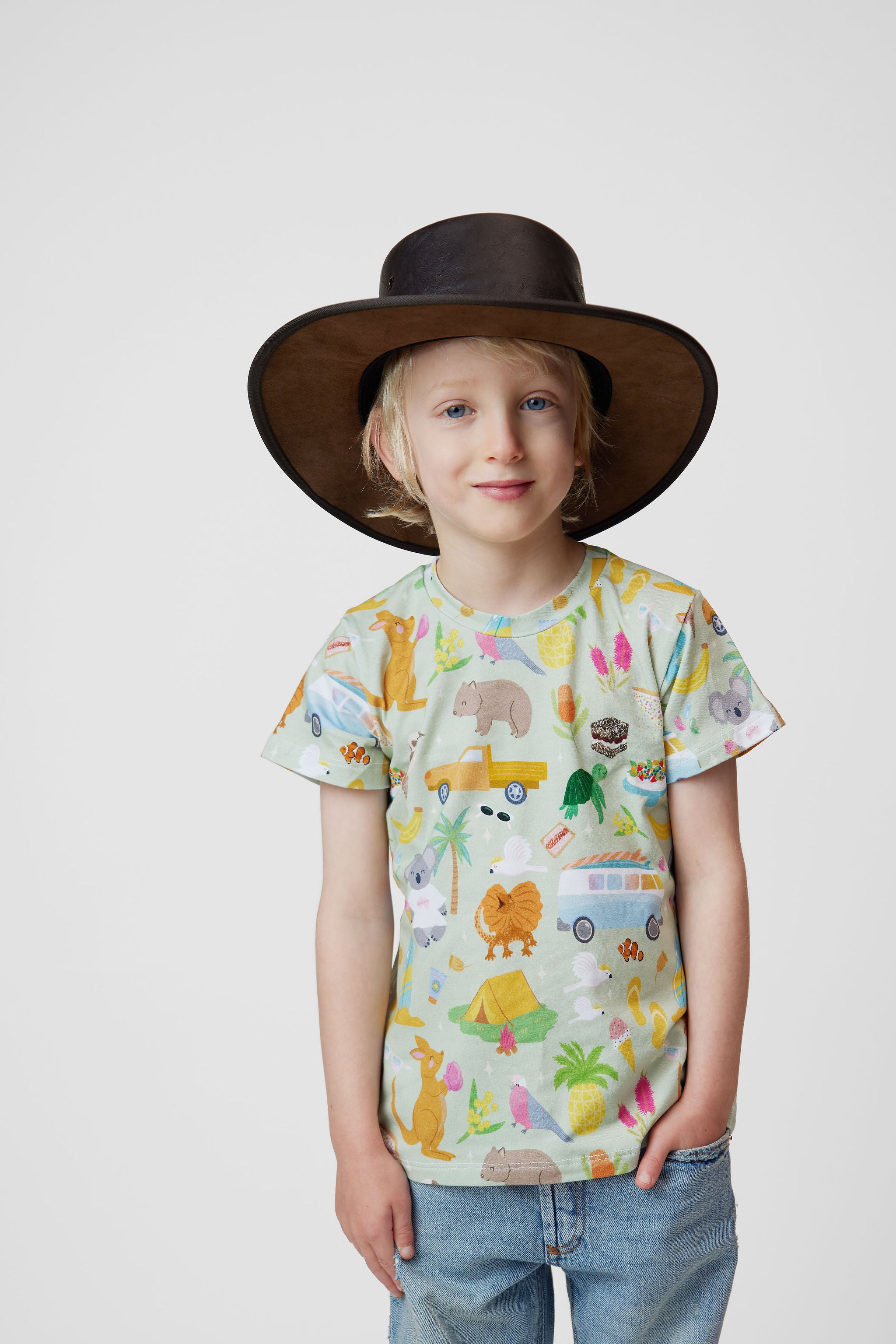 Child wearing Pebble and Poppet Summer Down Under organic cotton kids t-shirt with Australian inspired print featuring kangaroos, kombis, camping and native animals. Designed and made in Australia.