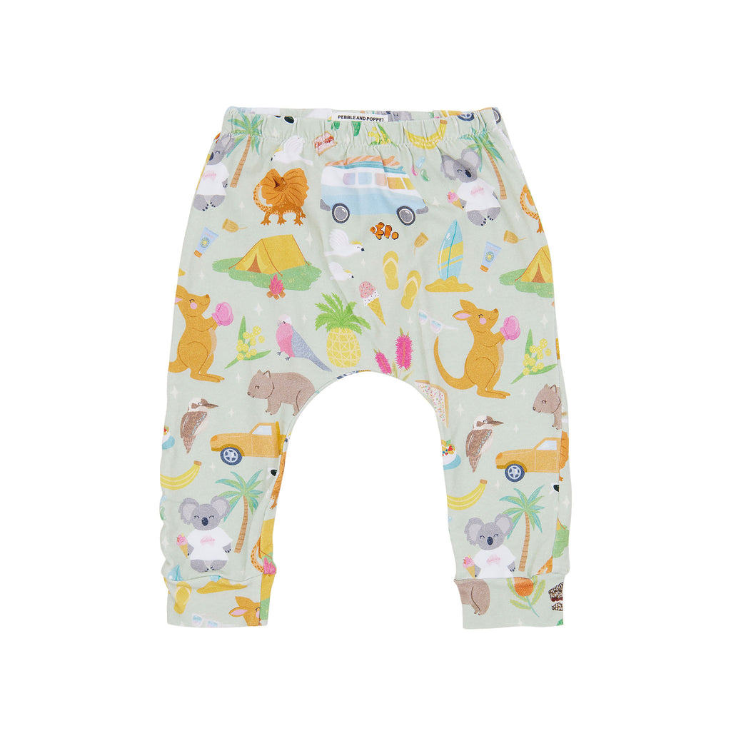 Summer Down Under organic cotton baby pants featuring Australian animals, kombis, camping and beach holiday illustrations on a soft sage green background by Pebble and Poppet.