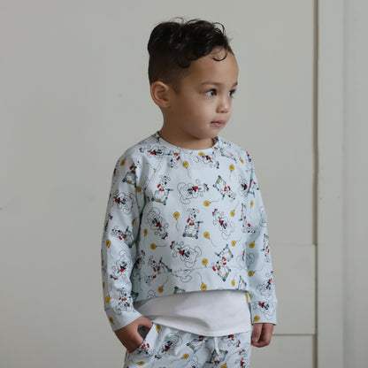 Toddler wearing matching organic cotton puppy print sweater and shorts set